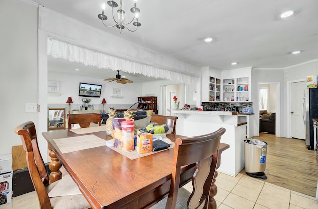 dining space with light tile patterned floors, recessed lighting, and ceiling fan with notable chandelier