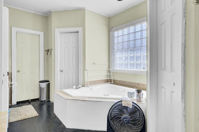 bathroom with crown molding and a bath