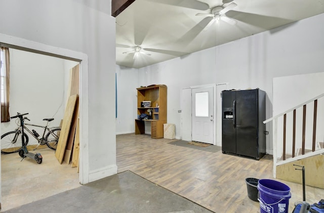 interior space with a ceiling fan and wood finished floors