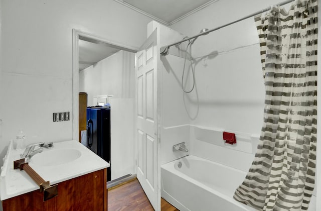 full bathroom featuring wood finished floors, vanity, and shower / bath combo