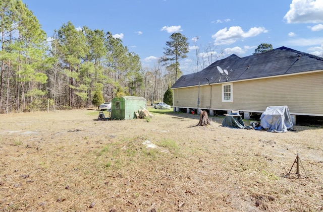 view of yard with an outbuilding and a storage shed