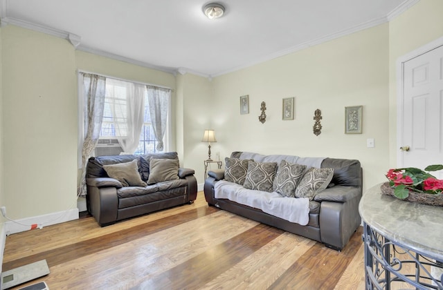 living area with crown molding, wood finished floors, and baseboards