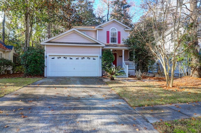 traditional home featuring covered porch, concrete driveway, and an attached garage