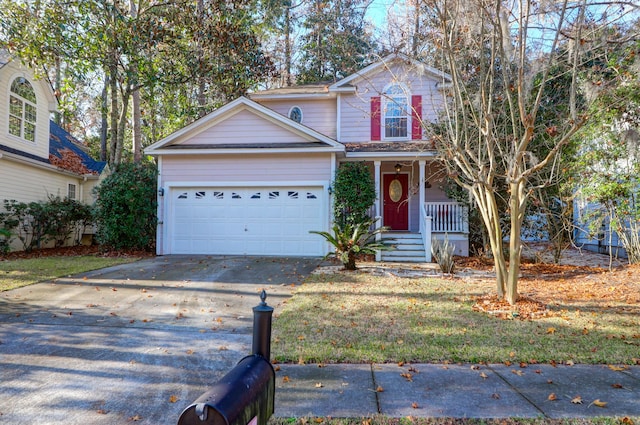 traditional-style home with a front yard, an attached garage, a porch, and driveway