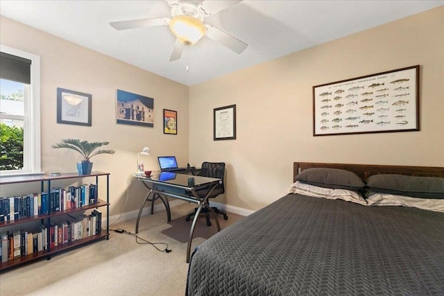 bedroom with light carpet, ceiling fan, and baseboards