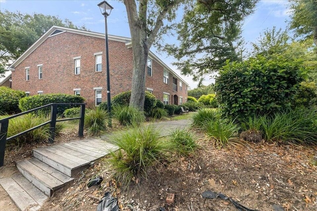 view of side of home with brick siding