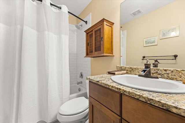 full bathroom with visible vents, shower / tub combo with curtain, vanity, and toilet