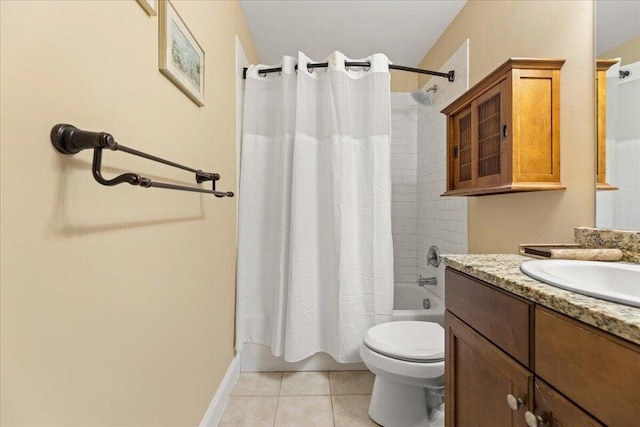 full bathroom with tile patterned flooring, toilet, shower / tub combo, vanity, and baseboards