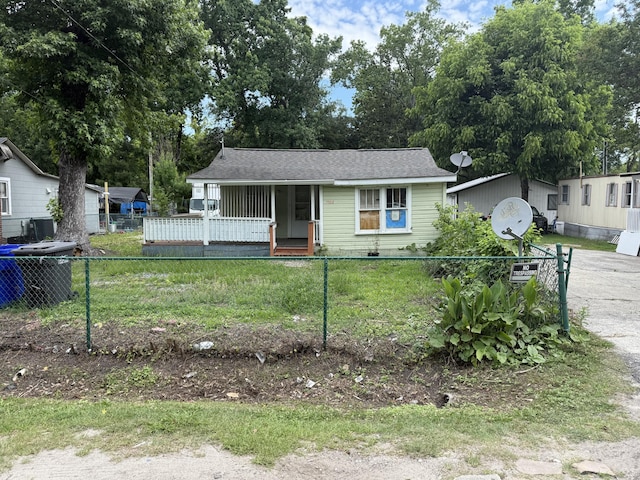 1902 Clifton St, North Charleston, SC 29406 - view of front facade with a fenced front yard, central AC, a porch, and roof with shingles