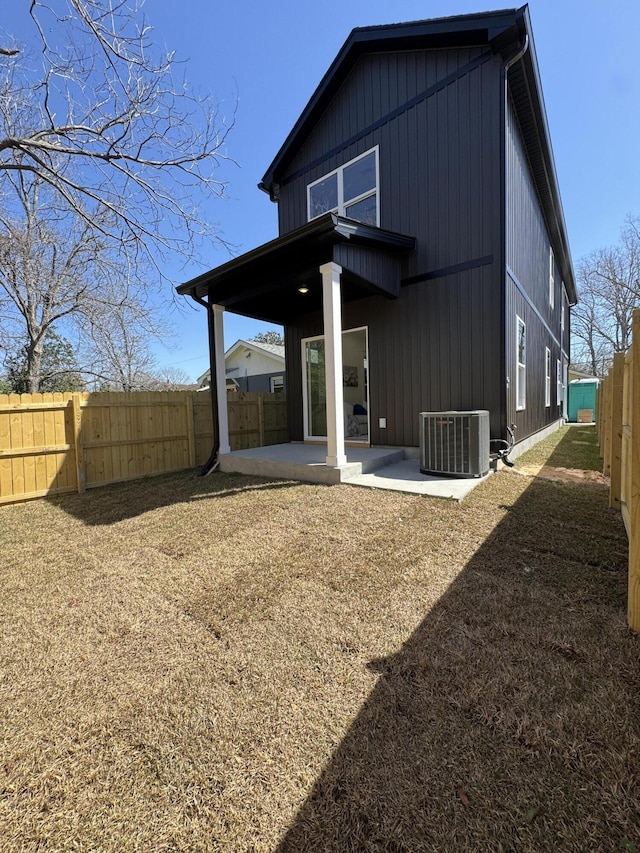 back of property featuring central air condition unit, a fenced backyard, and a patio area