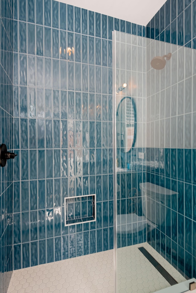 bathroom with tiled shower