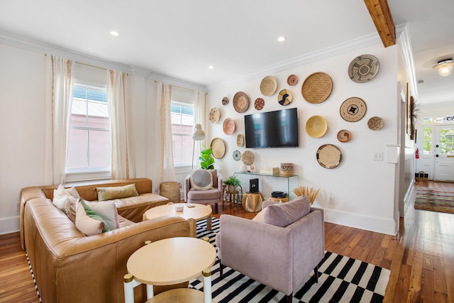 living room with light wood-type flooring, a wealth of natural light, and ornamental molding