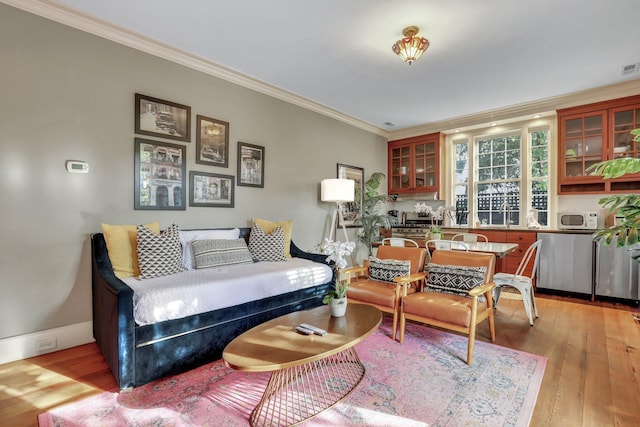 living room with light hardwood / wood-style floors and crown molding