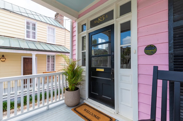 doorway to property featuring covered porch