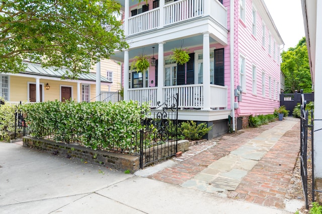 view of front of house with covered porch and a balcony