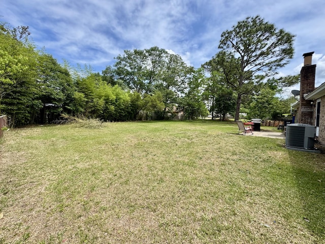view of yard with a patio and central air condition unit