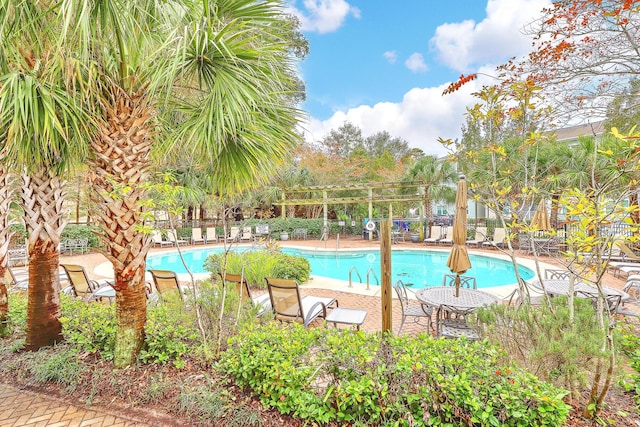 pool with a patio and fence