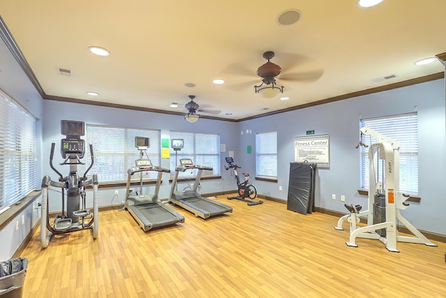 exercise room featuring visible vents, baseboards, ceiling fan, and light wood-style flooring