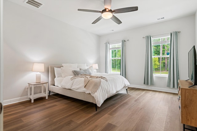 bedroom featuring wood finished floors, baseboards, and ceiling fan