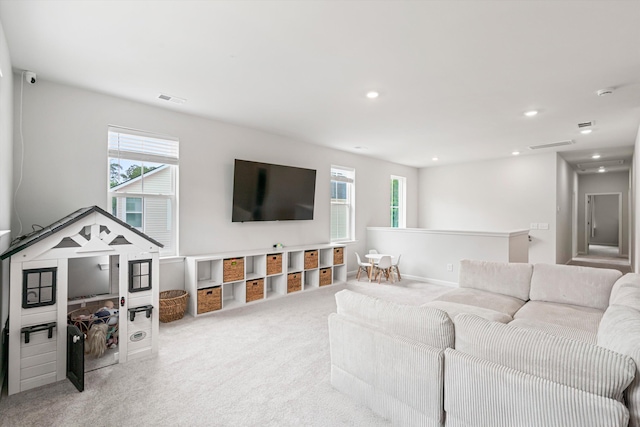 living room featuring plenty of natural light, carpet, and recessed lighting