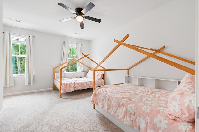carpeted bedroom with a ceiling fan and baseboards