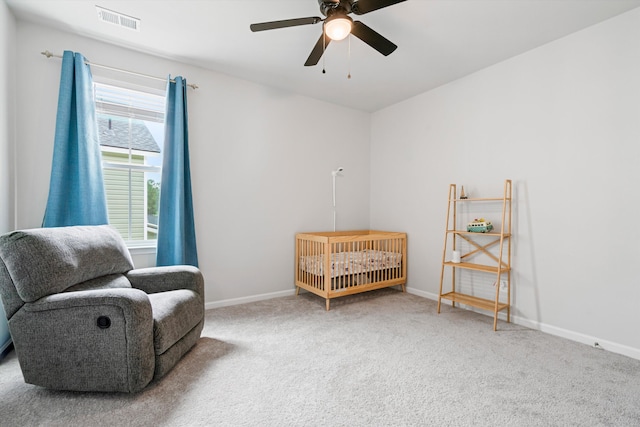 sitting room featuring carpet floors, a ceiling fan, and baseboards