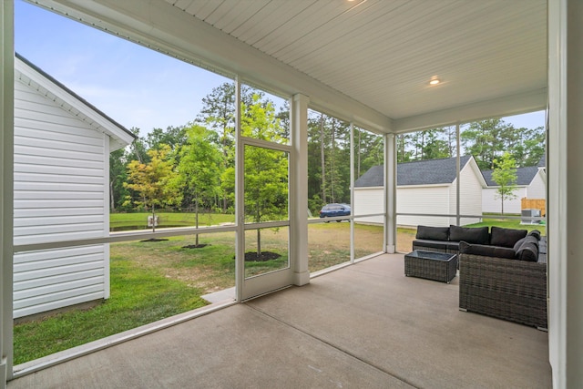 sunroom / solarium featuring outdoor lounge area and view of scattered trees