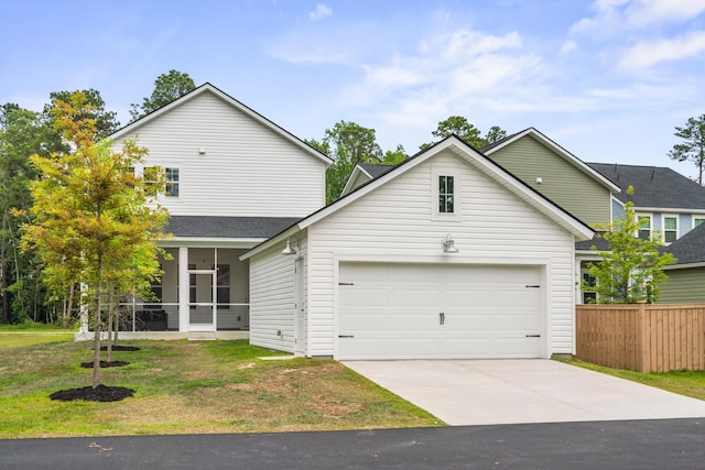 traditional-style house featuring concrete driveway, a sunroom, and roof with shingles