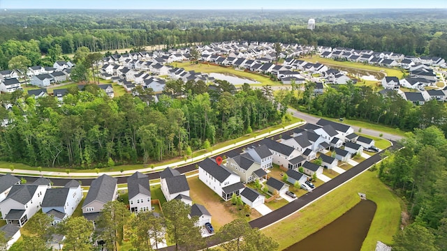 aerial overview of property's location with nearby suburban area and a heavily wooded area