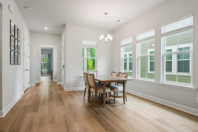 dining area with light wood-style floors, a chandelier, baseboards, and recessed lighting