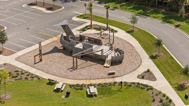 view of community featuring uncovered parking