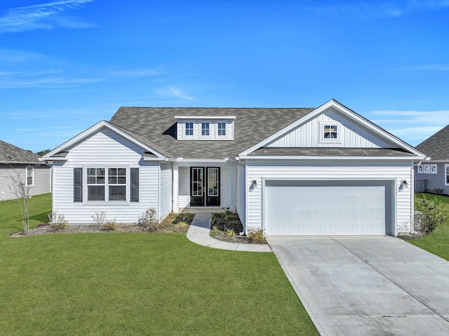 view of front of property with a front yard and a garage