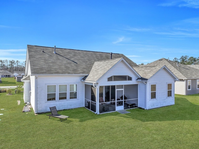 back of property featuring a lawn and a sunroom