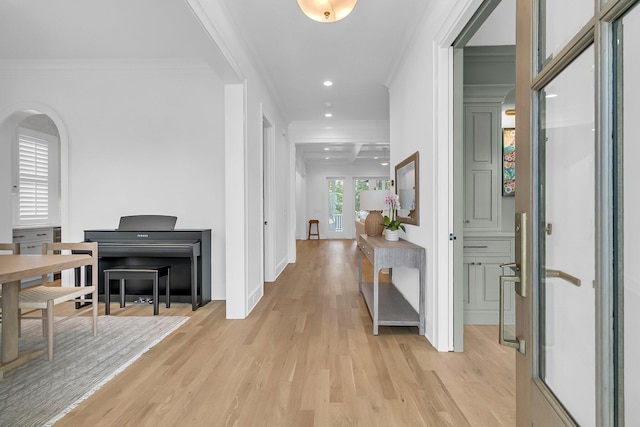 hall featuring recessed lighting, arched walkways, light wood-style floors, and ornamental molding