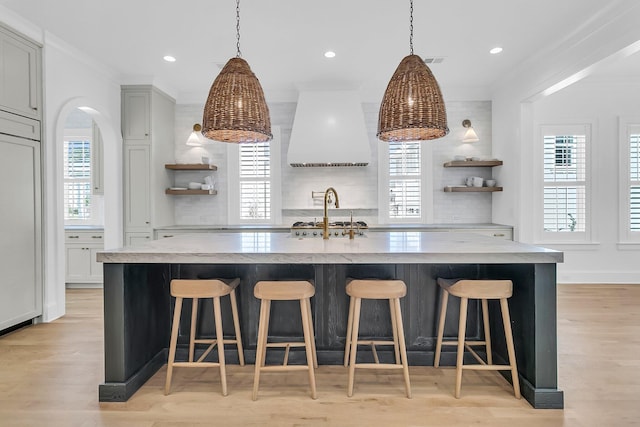 kitchen with a wealth of natural light, decorative backsplash, and open shelves