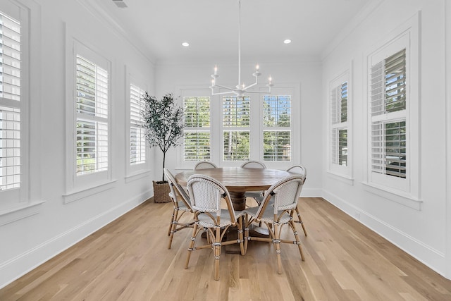 dining space featuring light wood finished floors, crown molding, baseboards, a chandelier, and recessed lighting