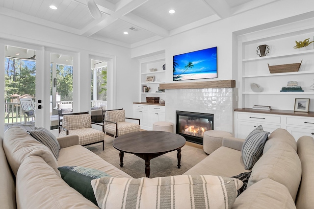 living room featuring beam ceiling, built in features, coffered ceiling, recessed lighting, and a fireplace