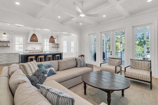 living room featuring recessed lighting, french doors, beam ceiling, and light wood-style floors