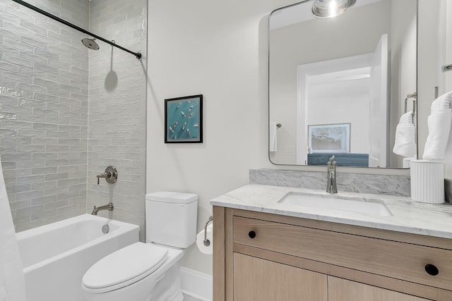 bathroom with tub / shower combination, toilet, and vanity