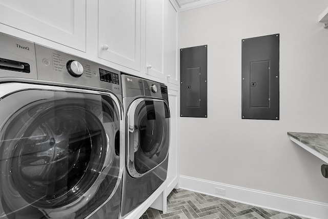 laundry area with electric panel, cabinet space, baseboards, and washing machine and clothes dryer