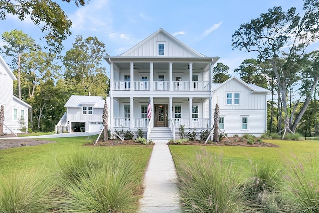 view of front of property featuring covered porch, board and batten siding, a front yard, a balcony, and ceiling fan