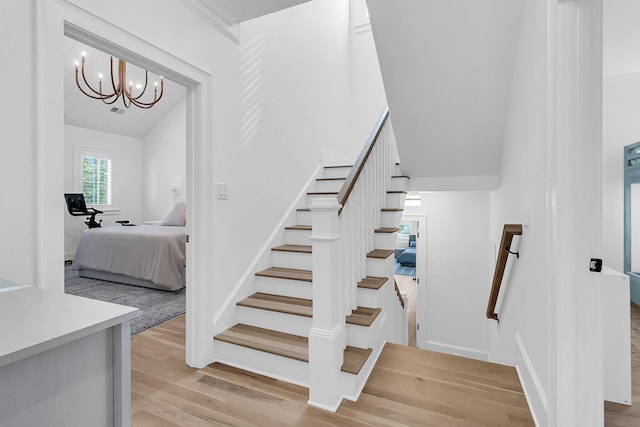 stairway featuring vaulted ceiling and wood finished floors