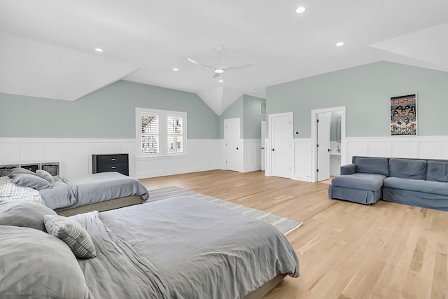 bedroom with light wood-type flooring, lofted ceiling, recessed lighting, wainscoting, and a ceiling fan