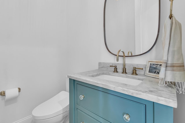 bathroom featuring toilet and vanity