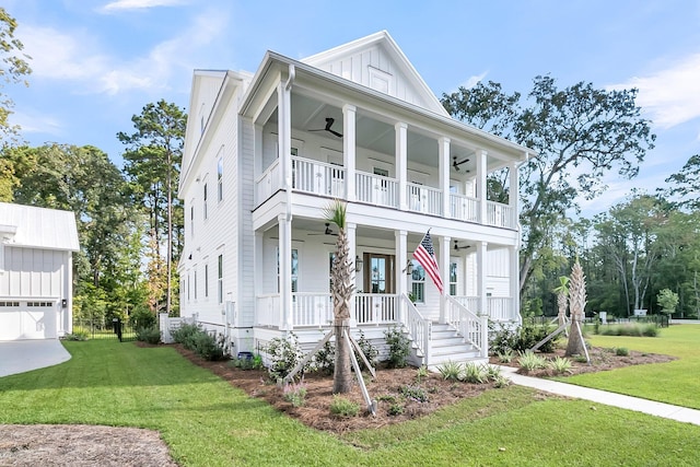 view of front of property with board and batten siding, a front lawn, a porch, a balcony, and a ceiling fan