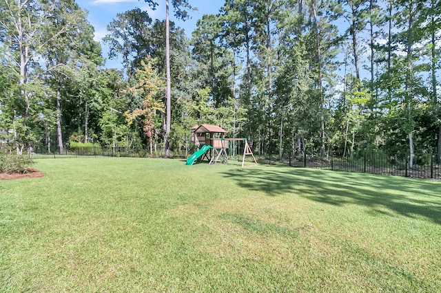 view of yard featuring fence and a playground