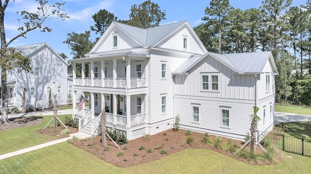 view of front of house with a porch, a front yard, and board and batten siding