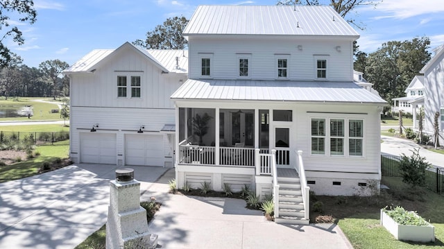 view of front of home featuring a garage, fence, driveway, and a sunroom