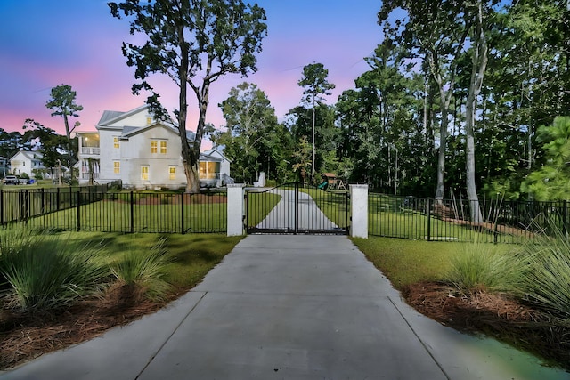 view of gate with a lawn and fence private yard