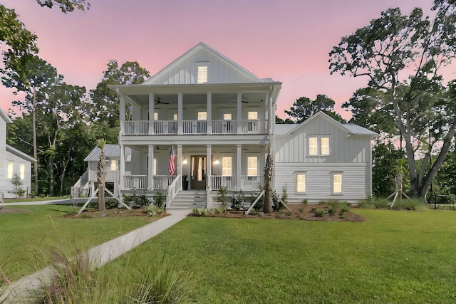 view of front of house featuring a porch, a front lawn, board and batten siding, and a ceiling fan